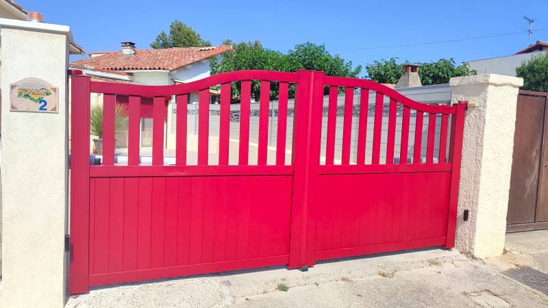 Un portail à double battant en aluminium rouge motorisé, modèle Authentique, pour une entrée de caractère à Aix-en-Provence